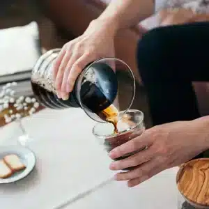 A man keep V60 PITCHER GLASS in one hand and one glass on other